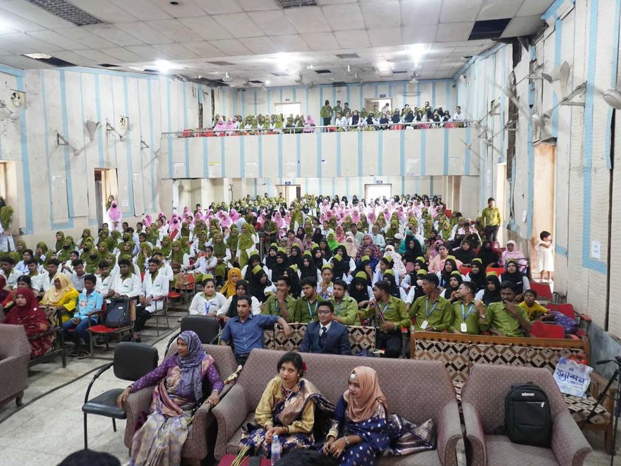 Students and staff at a college assembly